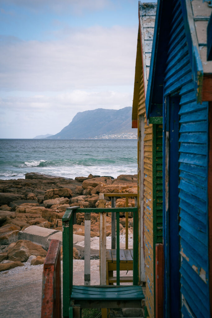 Coloured houses (changing rooms) on St. James beach with ocean on the background