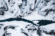 Fjaðrárgljúfur Canyon covered in snow top down drone shot
